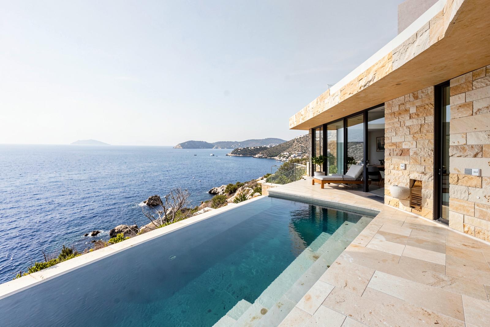 Stone and glass residence above the Adriatic with an infinity pool